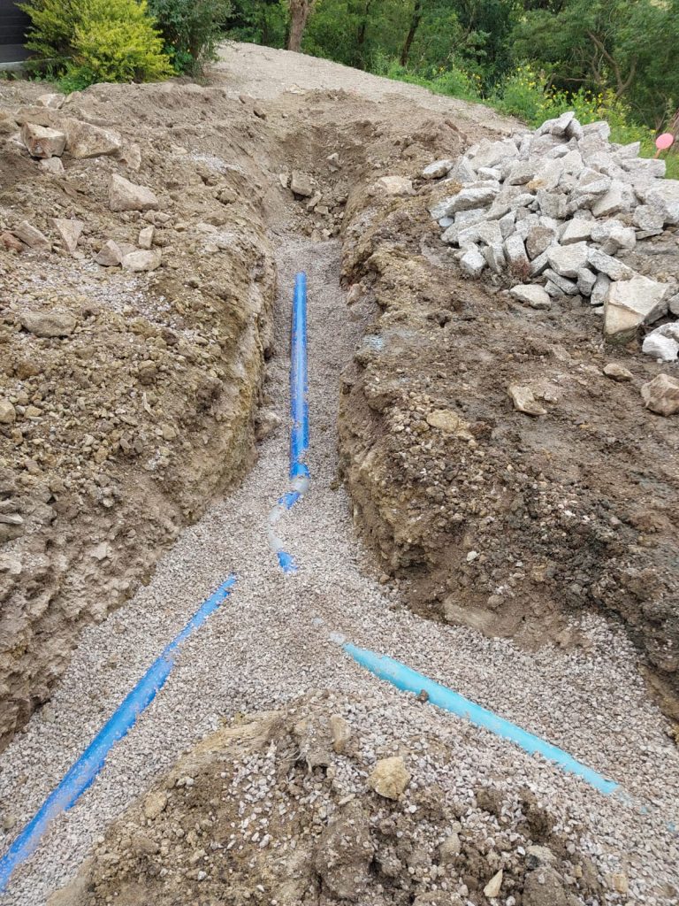 Tranchées d'assainissement avec canalisations sur lit de gravier à Saint-Georges-de-Montaigu